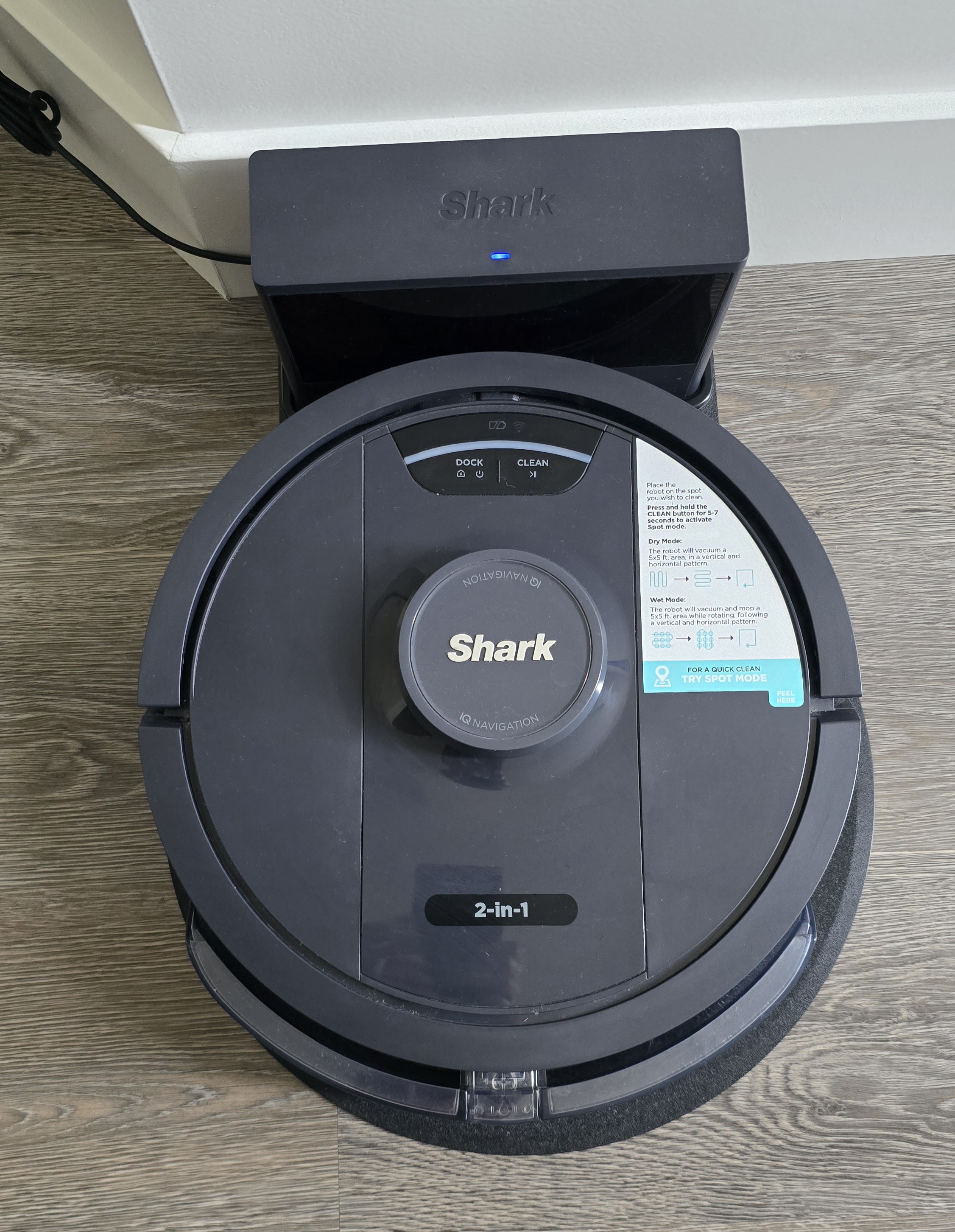 Shark self-emptying robot vacuum on its docking base